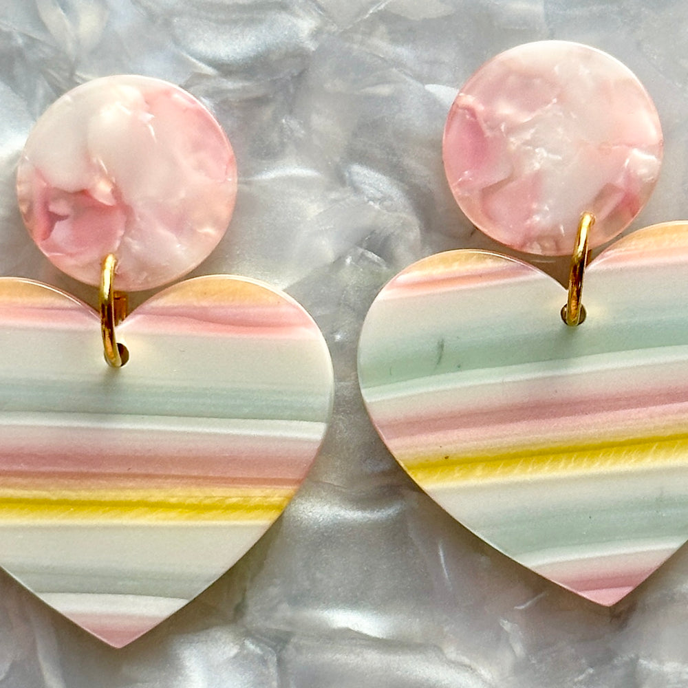 woman wearing acrylic Heart Earrings in I Pink I Love You, white, yellow, and blue 