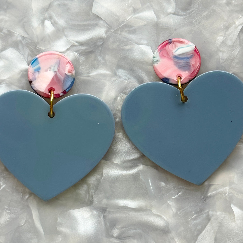 Woman wearing Acrylic Heart Earrings in Love Is In The Air, blue, pink and red 