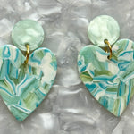 Close up of Acrylic Heart Earrings in Mint To Be, light blue, green, and white 