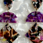 woman wearing Acrylic Hemisphere drop earrings in purple and dark multicolor