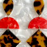 woman wearing Acrylic Hemisphere dropearrings in a red, brown and black 