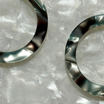 Woman wearing  Close up of Acrylic Hoop Earrings in gray and green 