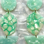 woman wearing a Acrylic Pendulum Drop Earrings in mint green 