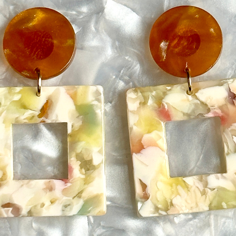 woman wearing Acrylic Square Drop Earrings in All Fun and Games, yellow, cream, blue, green and brown 