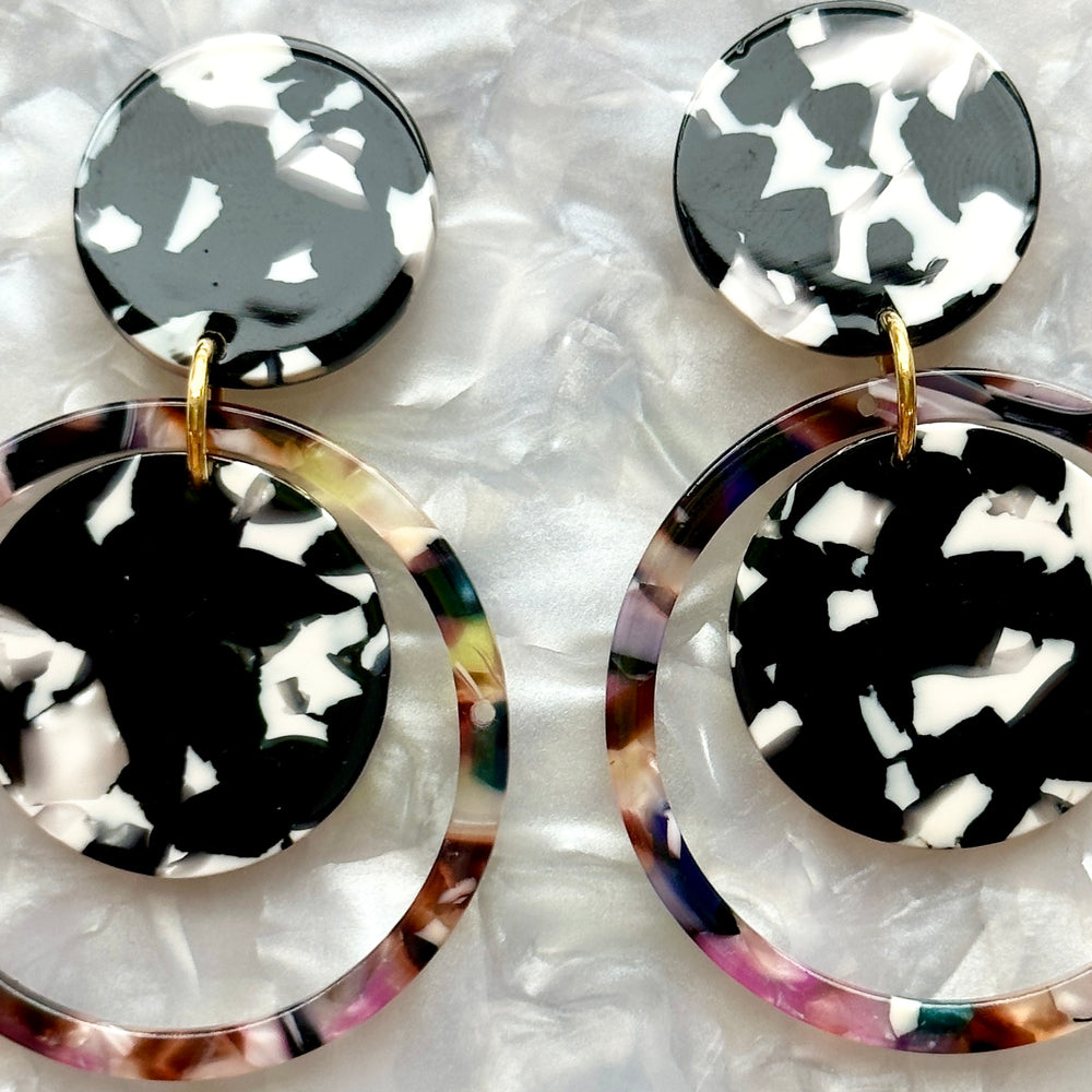 woman wearing Acrylic orbital drop earring in black, white and dark multicolor