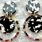 woman wearing Acrylic orbital drop earring in black, white and dark multicolor