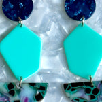 woman wearing Acyrlic Pendulum Drop Earrings in Along For The Vibe, navy blue and teal green 