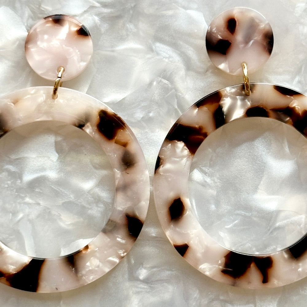 woman wearing acrylic open circle drop earring in pearly tortoise, black and white