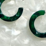 women wearing mini acrylic hoop earrings in dark green and navy 