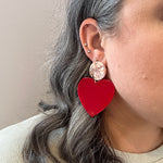 Woman wearing  Acrylic Heart Earrings in At First Blush, red and pink 