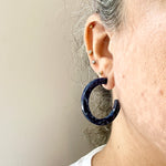 Woman wearing Acrylic Hoop Earrings in navy blue