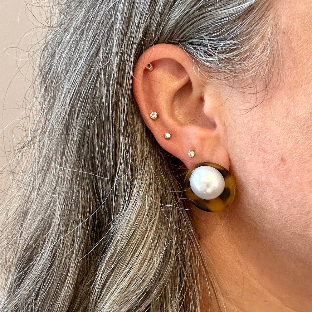 Woman wearing Acrylic Stud earring in brown, black and sliver 