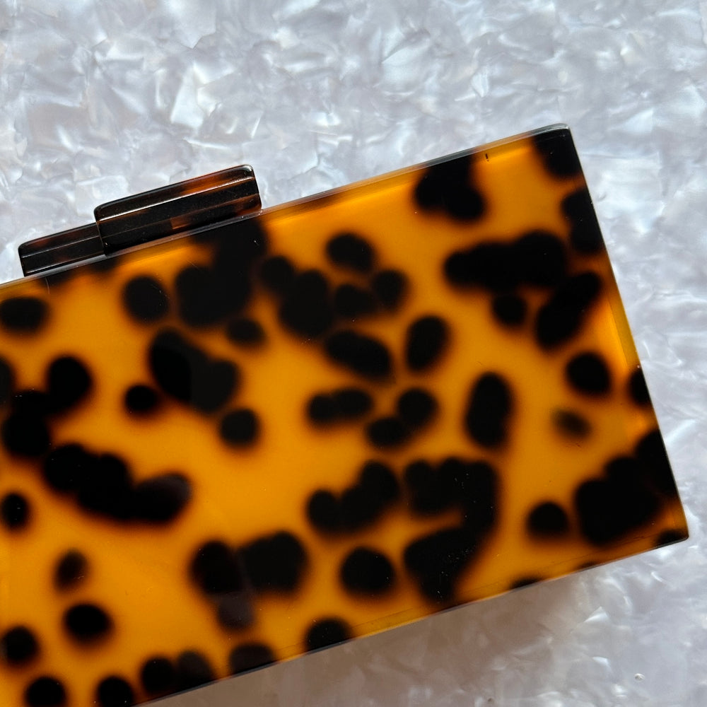 acrylic clutch purse in tortoise_hot pink interior close up