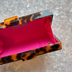 acrylic clutch purse in tortoise_hot pink interior close up