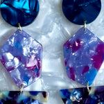 close up of Acrylic Pendulum drop earrings in blue and purple 