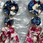 woman wearing a Acrylic Circle fan drop earring in blue and magenta pink mix