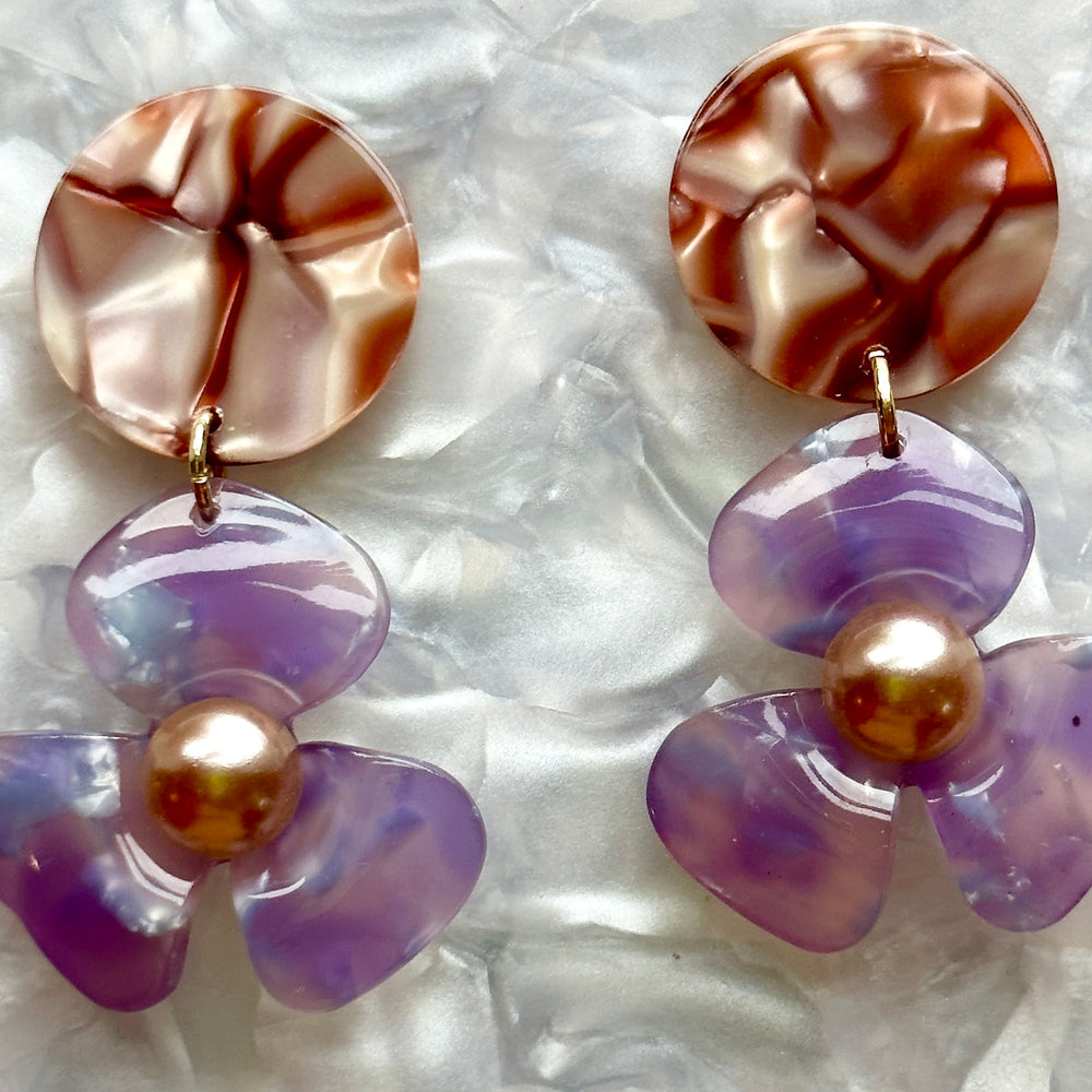 close up of Acrylic Flower Drop Earrings in purple and brown