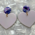 close up of Acrylic Heart Earrings in Lilac You A Lot and deep purple 