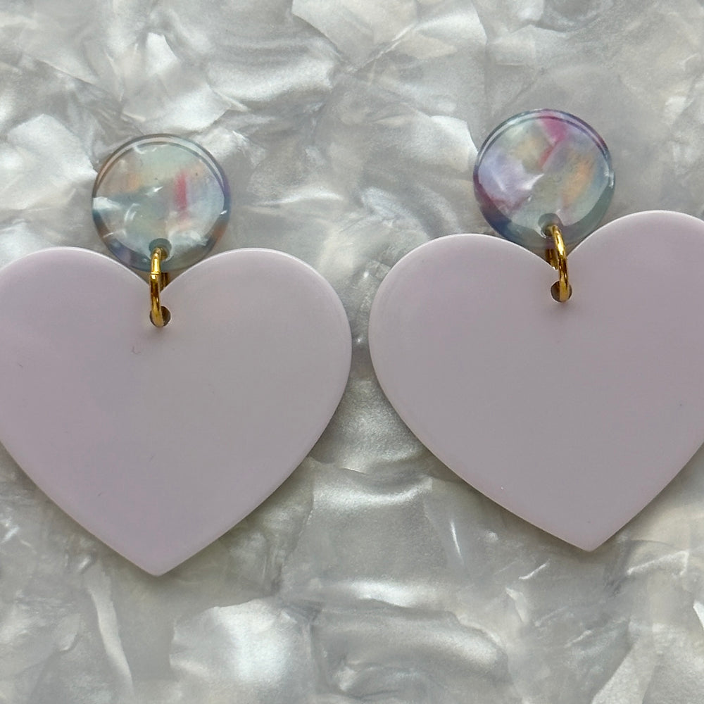 close up of Acrylic Heart Earrings in So In Love, purple and light blue 