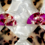 woman wearing a Acrylic Hemisphere drop earrings in black, white, pink and red