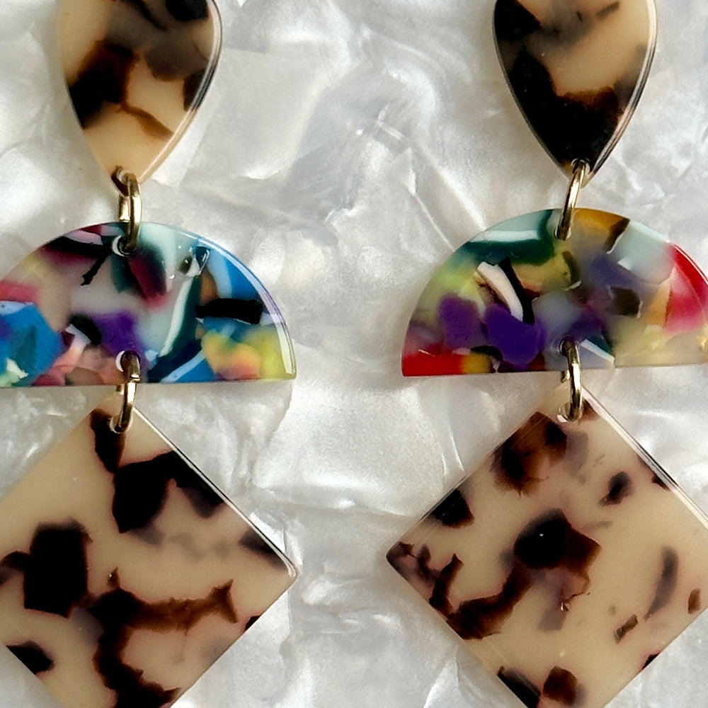 woman wearing a Acrylic Hemisphere drop earrings in multicolor, black and white 