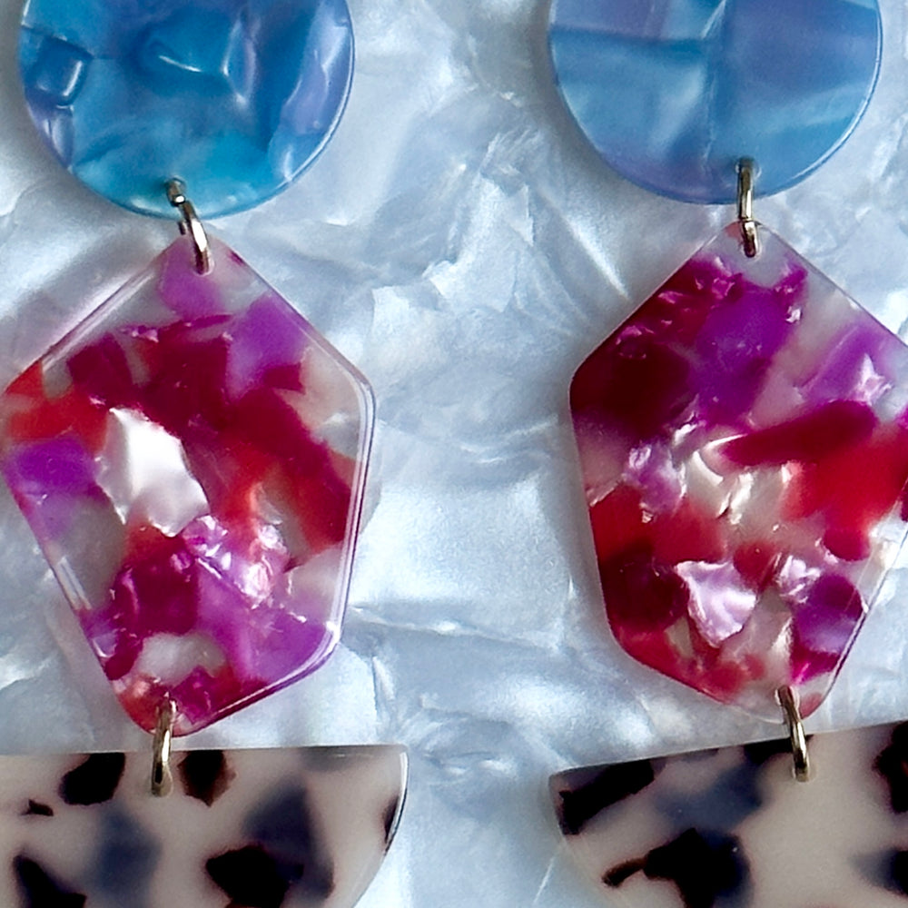 woman wearing  Acrylic Pendulum Drop Earrings in Berry In Love, blue, purple, red, beige, and Black 