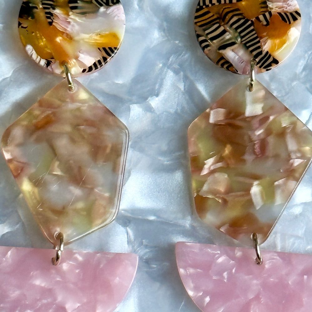 woman wearing Acrylic Pendulum Drop Earrings in Centerpiece of Attention, pink, black, white and orange 