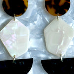 woman wearing Acrylic Pendulum Drop Earrings in Chic Into The Night, black, brown, and white