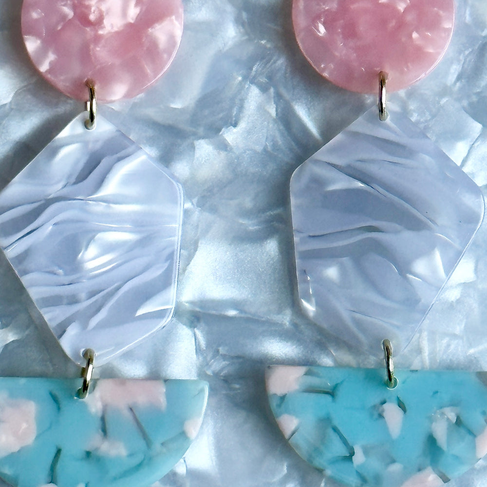 woman wearing Acrylic Pendulum Drop Earrings in Lover, pink, gray, and light blue 