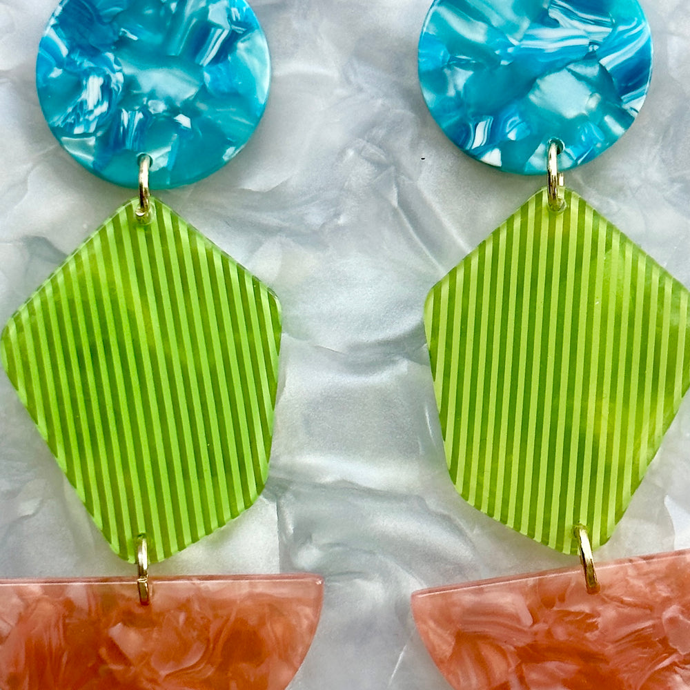 woman wearing a Acrylic Pendulum Drop Earrings in blue, green and pink