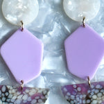 woman wearing Acrylic Pendulum Drop Earrings in white and purple 