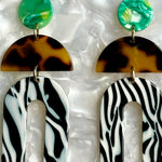 woman wearing Acrylic arch drop earring in tortoise, green, black and white 