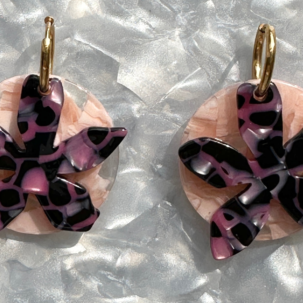 close up with Acrylic convertible hoop earrings in a mix of black and pink