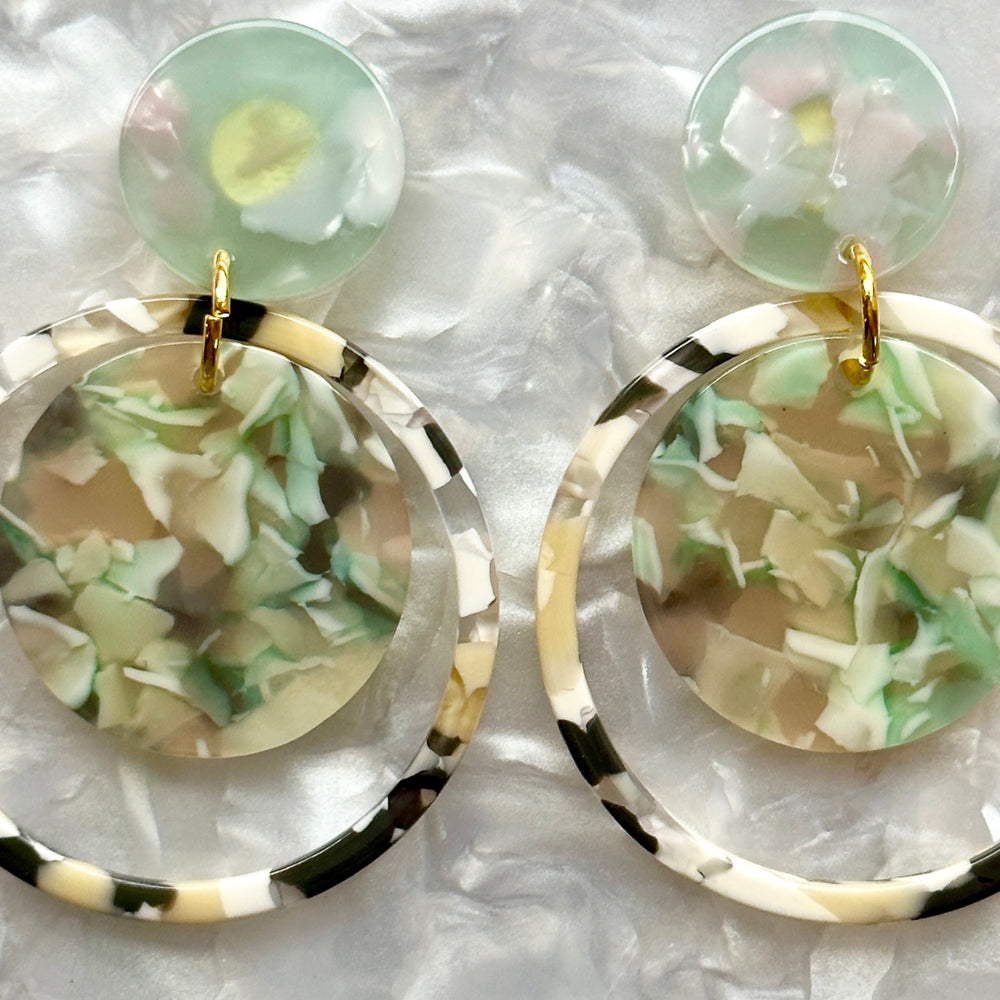 woman wearing a Acrylic orbital drop earring in mint green, beige, and gray 