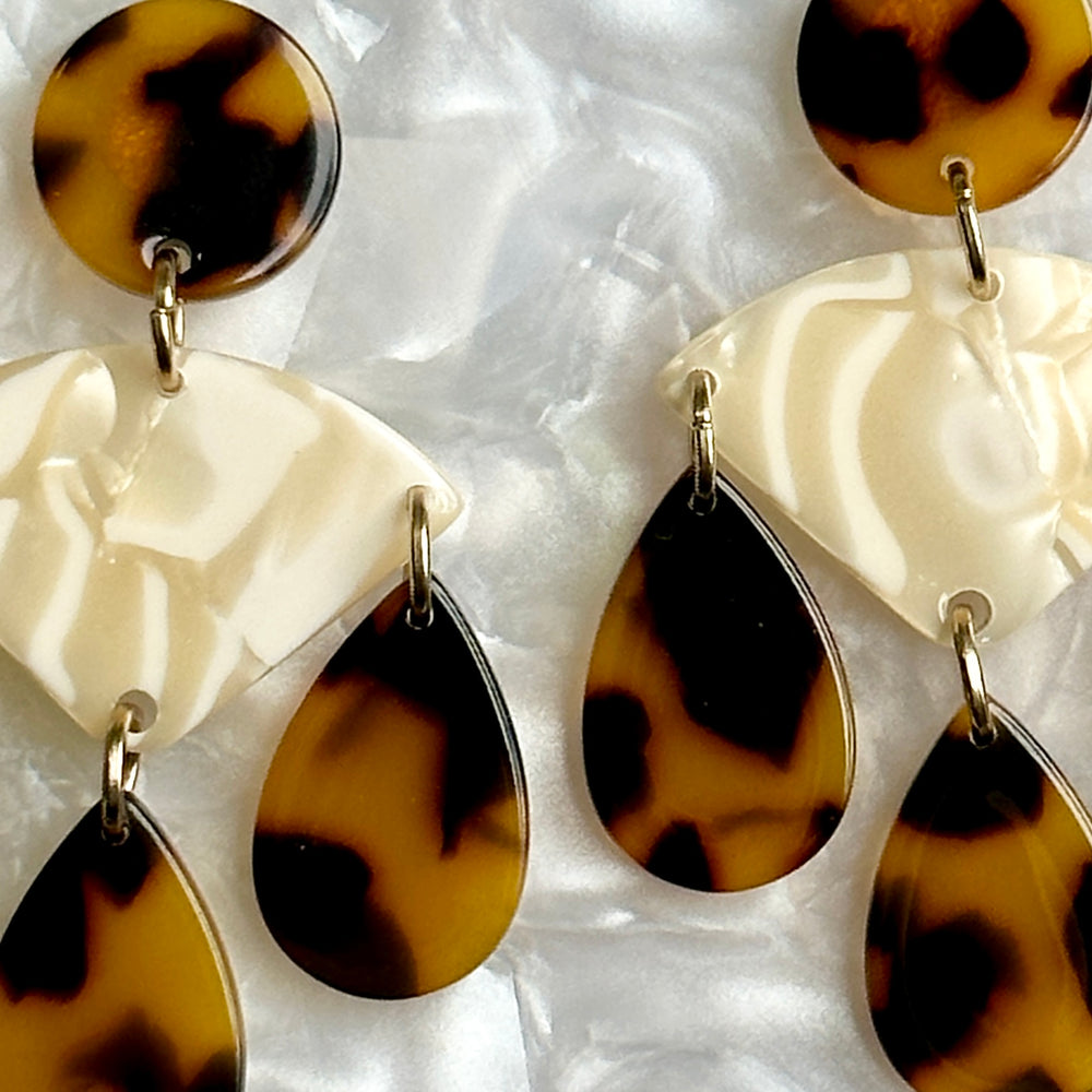 woman wearing acrylic Chandelier Drop Earrings in cream and tortoise