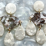 woman wearing acrylic Chandelier Drop Earrings in gray and white