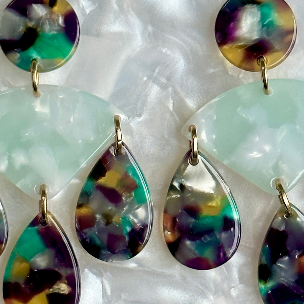 woman wearing acrylic Chandelier Drop Earrings in green, purple and yellow