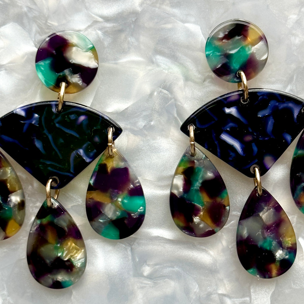 woman wearing acrylic Chandelier Drop Earrings in navy, green, yellow and purple