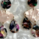 close up of acrylic Chandelier Drop Earrings in pink and multicolor