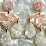 woman wearing acrylic Chandelier Drop Earrings in pink and white