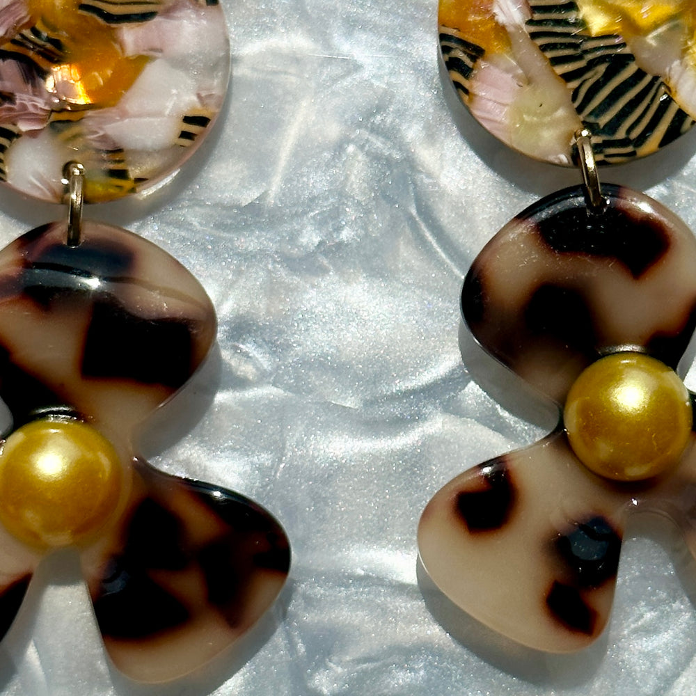 close up of acrylic Flower Drop Earrings in orange, pink and blonde tortoise