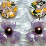 close up of acrylic Flower Drop Earrings in yellow, green and purple