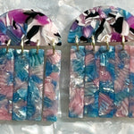 close up of acrylic Fringe Earrings in blue, purple, pink and black