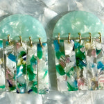 close up of acrylic Fringe Earrings in green, white, blue and pink