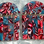 close up of acrylic Fringe Earrings in magenta pink and blue