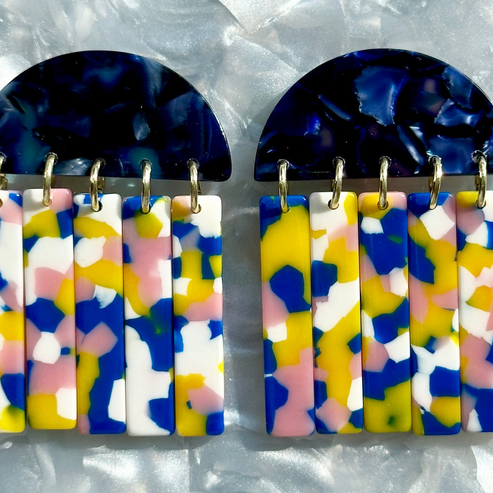 close up of acrylic Fringe Earrings in pink, blue, yellow and white