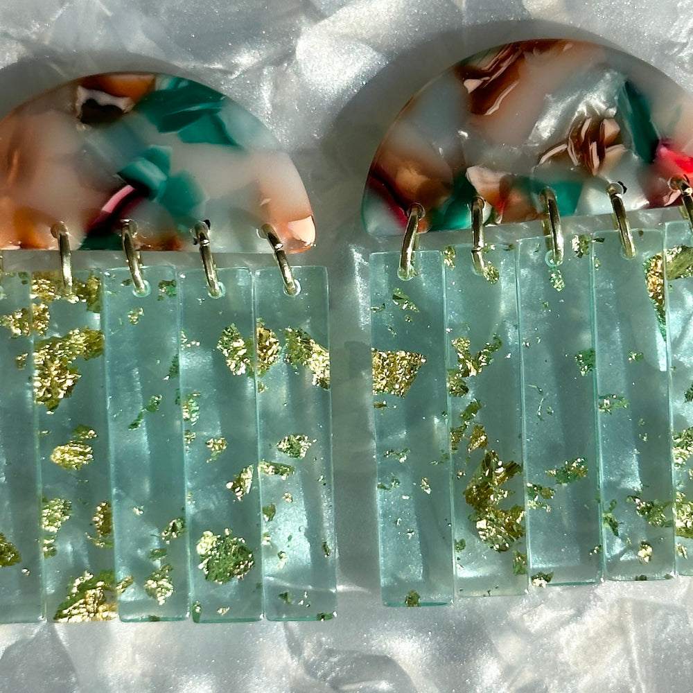 close up of acrylic Fringe Earrings in pink, green and brown