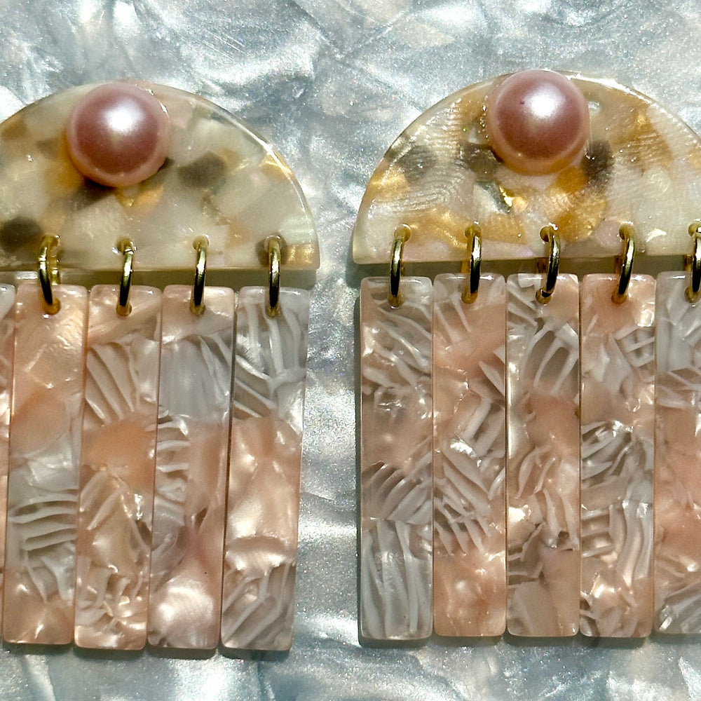 close up of acrylic Fringe Earrings in pink, white and beige