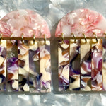 close up of acrylic Fringe Earrings in purple, pink and beige