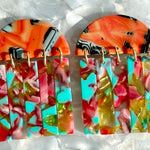 close up of acrylic Fringe Earrings in red, orange, yellow green and pink